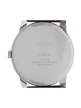 The back of a Timex watch with a stainless steel case and a dark brown leather strap, featuring engraved text on a white background.