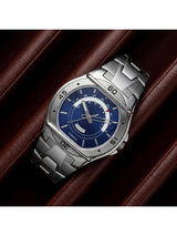 Silver watch with a blue face on a brown leather background