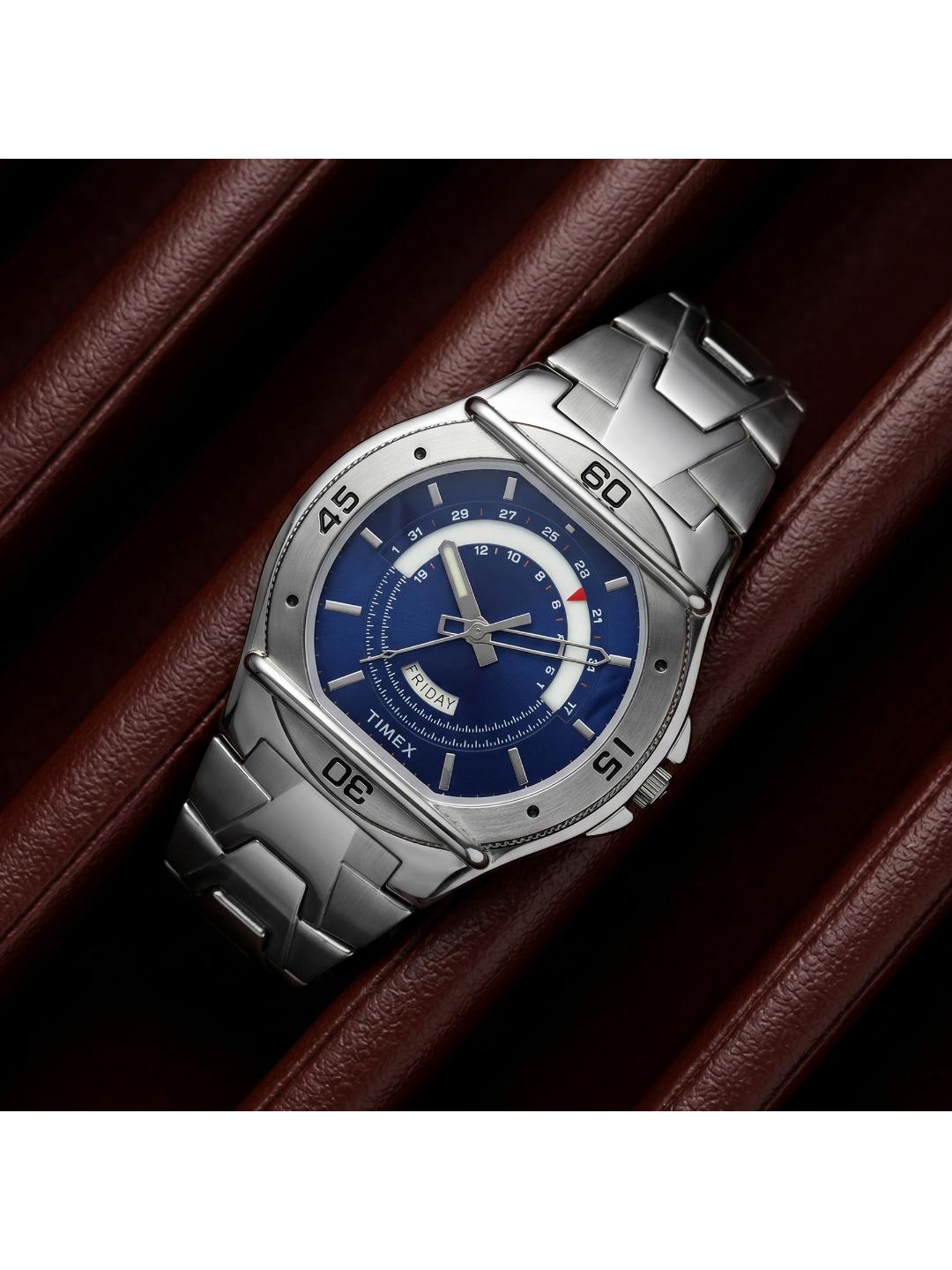 Silver watch with a blue face on a brown leather background