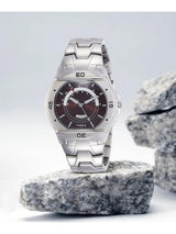 Silver Timex watch on a rock with a light gray background