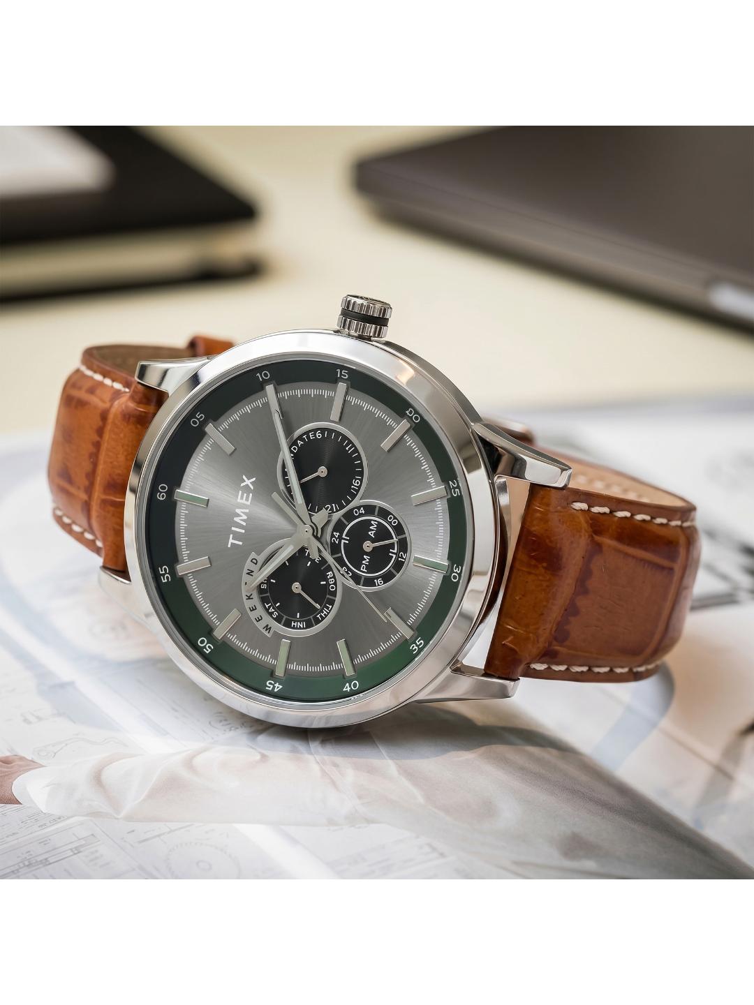 Timex watch with brown leather strap on a light surface