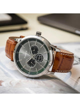 Timex watch with brown leather strap on a light surface