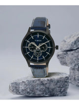 Timex watch with blue strap on a gray stone surface