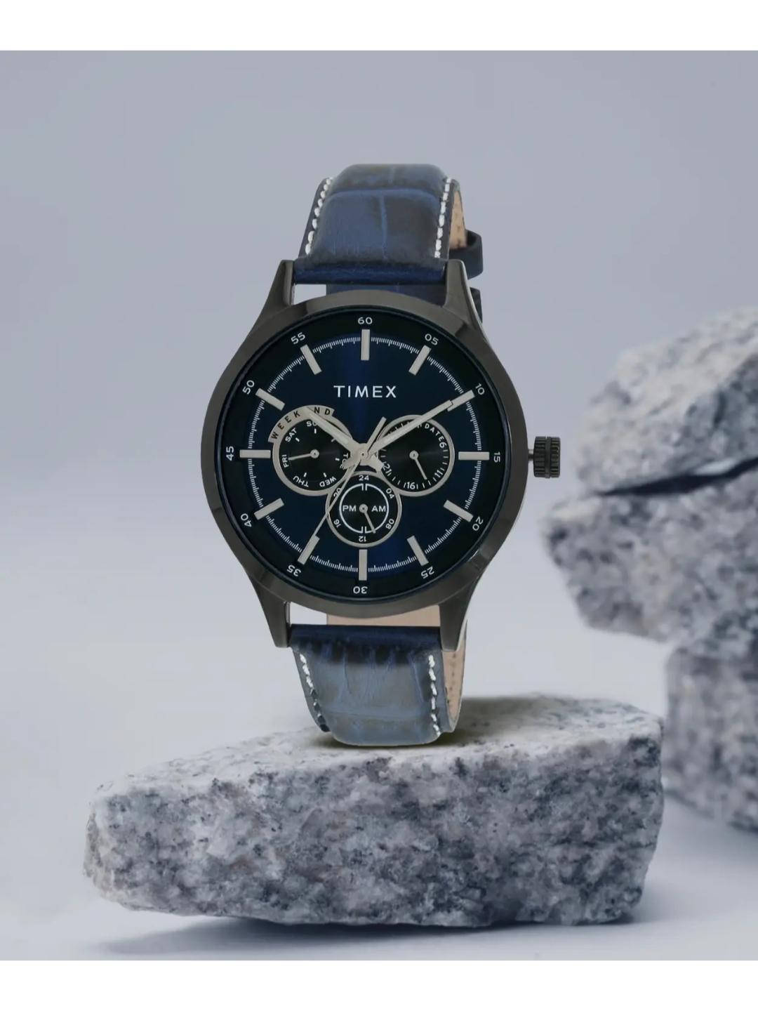 Timex watch with blue strap on a gray stone surface