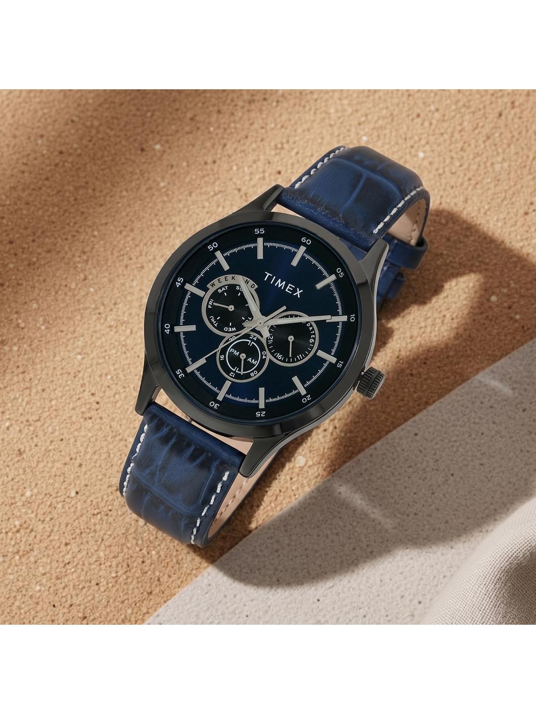 Timex watch with blue strap on a textured surface