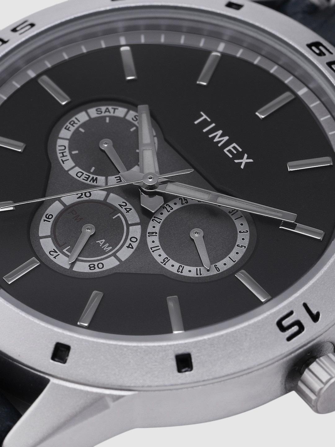 Timex watch with a black face and silver case on a white background