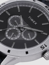Timex watch with a black face and silver case on a white background