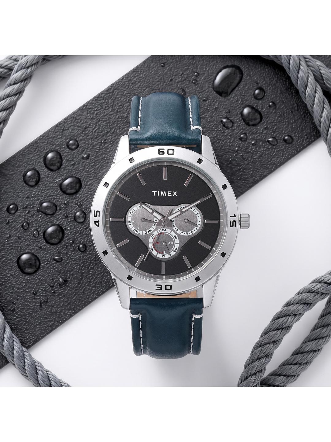 Timex watch with blue leather strap on a white background