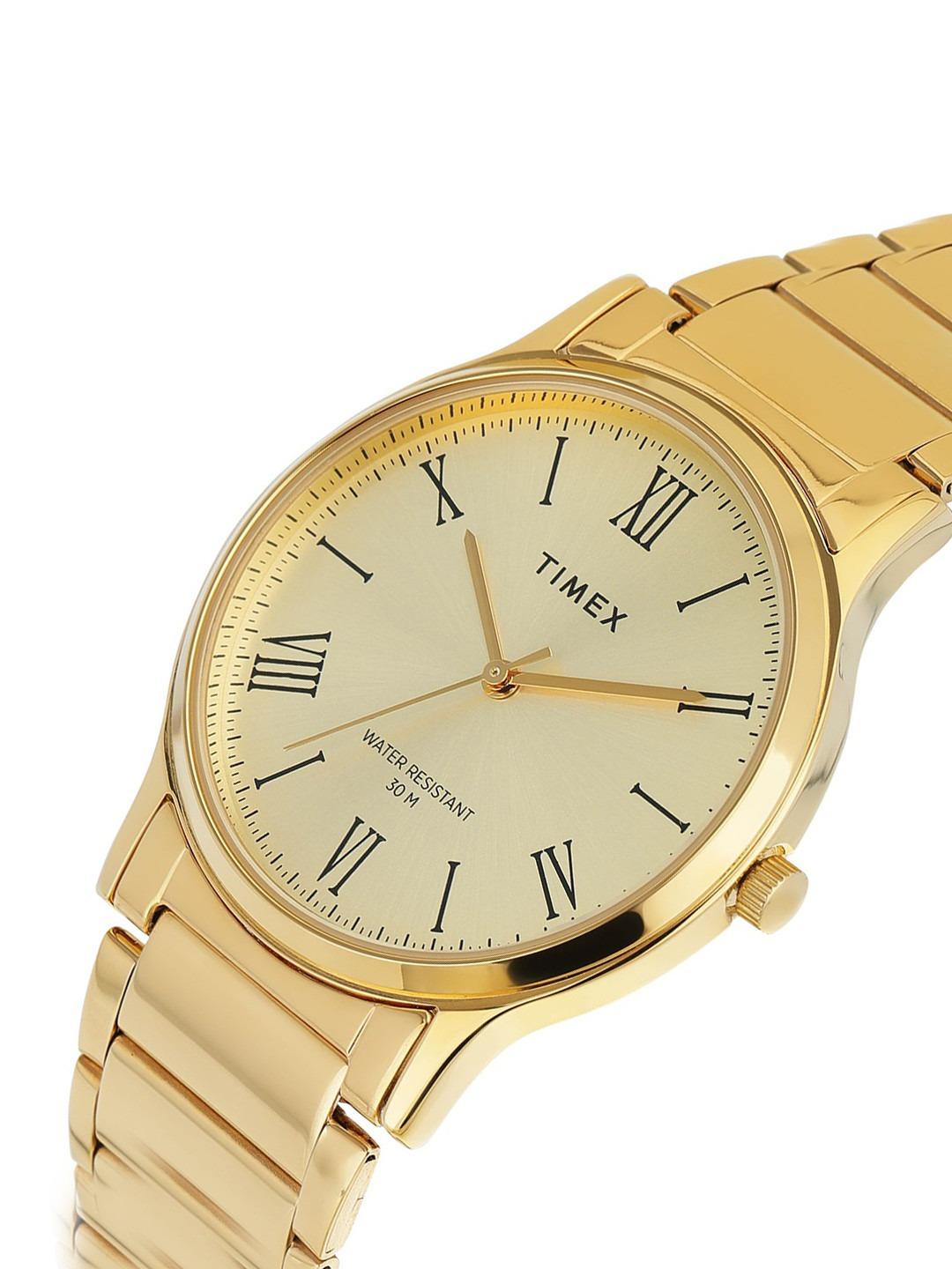 Gold Timex watch with a beige face on a white background