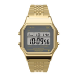 A gold-tone digital watch with a rectangular case, gold metal link bracelet, and a gray LCD display showing the time and digital calendar details. The brand name 'TIMEX' is visible on the watch face.