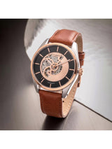 Timex watch with brown leather strap on a reflective surface