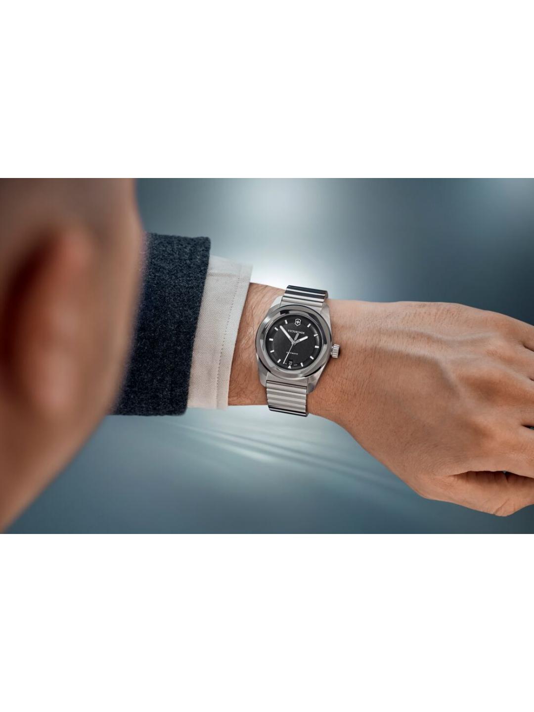 Silver watch on a wrist with a blurred background
