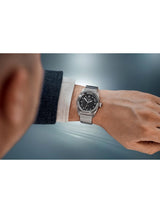 Silver watch on a wrist with a blurred background