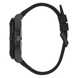 A black smartwatch shown from the side profile with a matte black silicone strap on a solid white background.